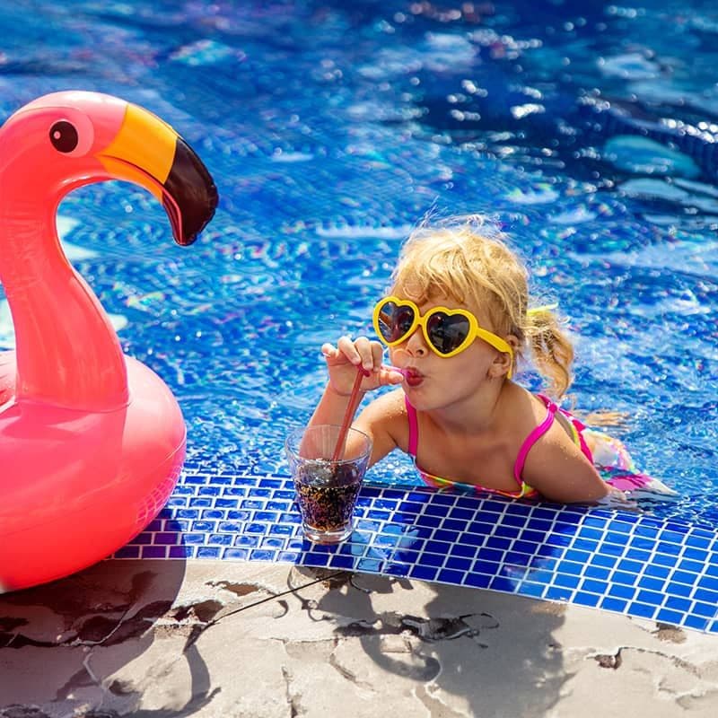 Young girl enjoying clear, swim-ready pool water maintained by Affordable Pool Care